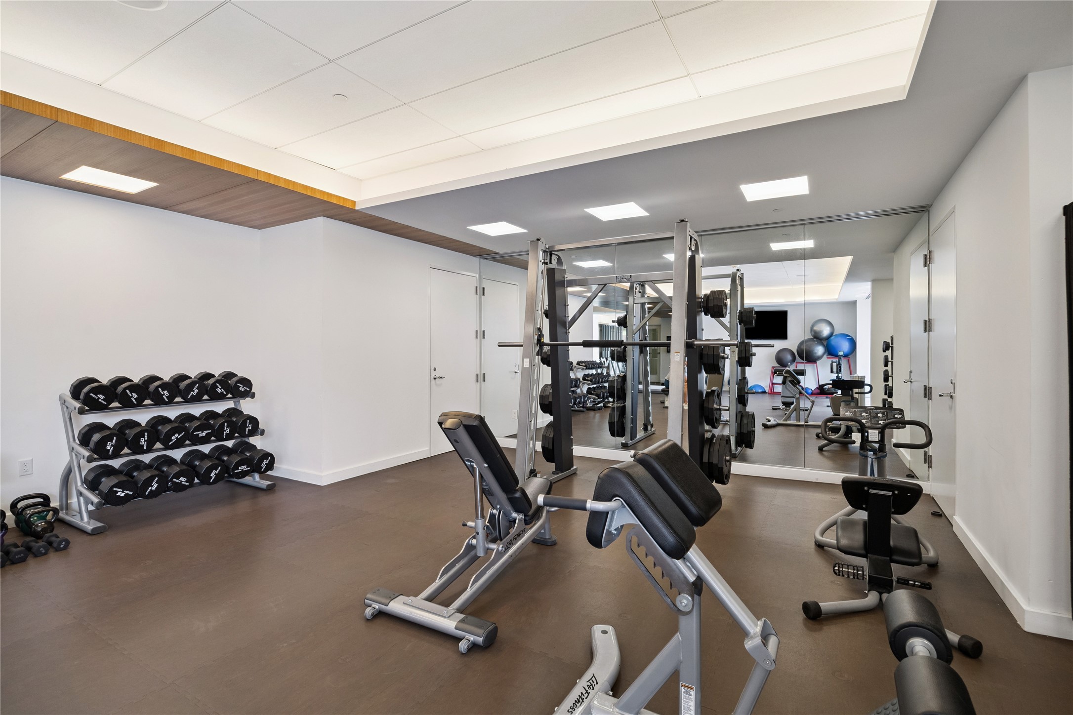 1111 Caroline Street, Unit 2908 Houston, TX 77010 - Photo 29 of 50 This well-equipped fitness space includes dumbbells, resistance machines, and a Smith rack, providing everything needed for focused strength training. Mirrors and open design create a bright, motivating environment to round out the Four Seasons fitness offerings.