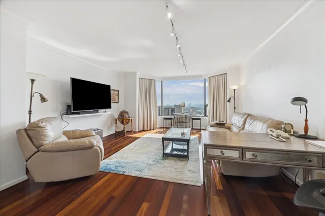 a living room with furniture and a large window