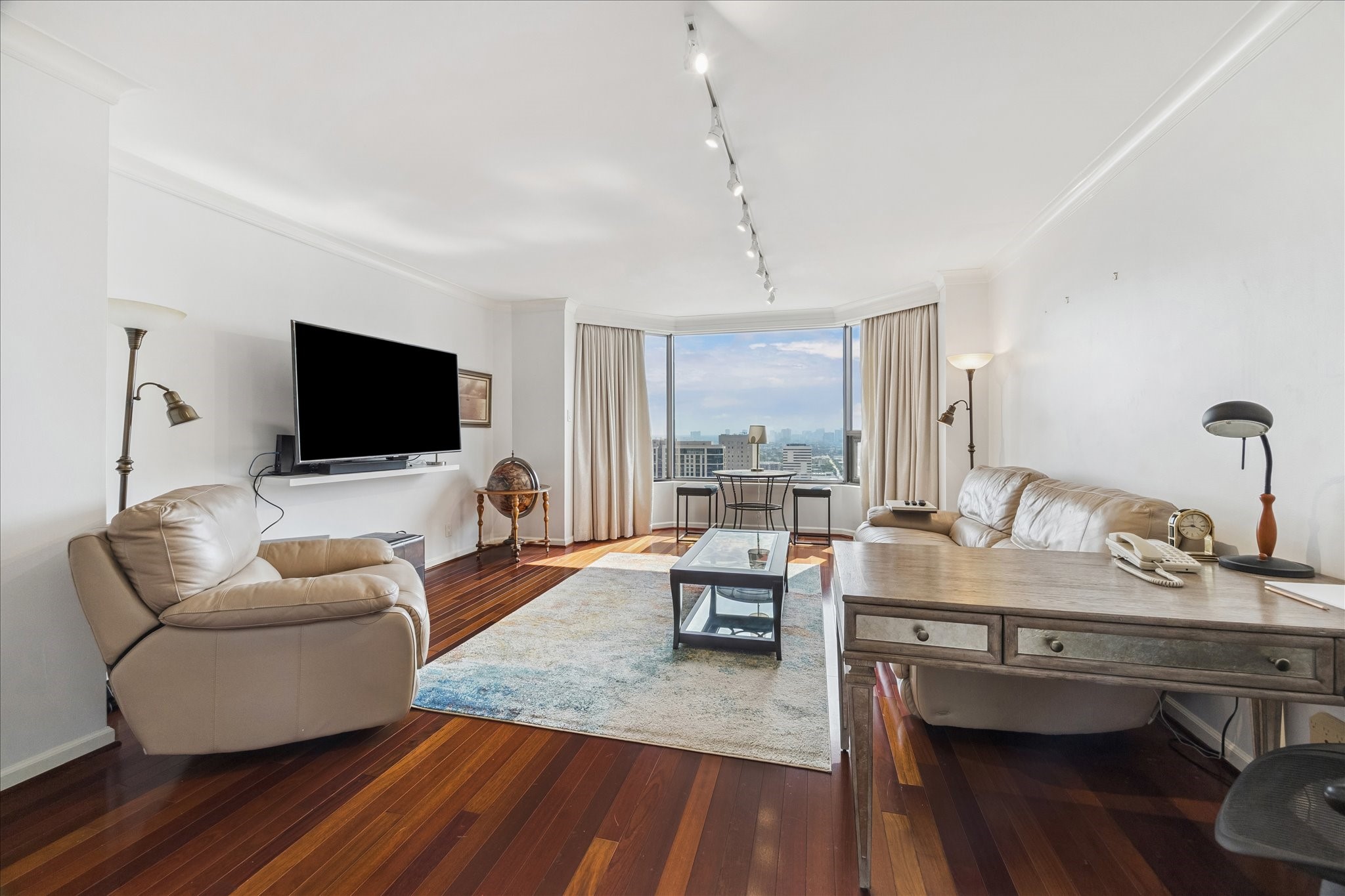 1111 Caroline Street, Unit 2908 Houston, TX 77010 - Photo 3 of 50 a living room with furniture and a flat screen tv
