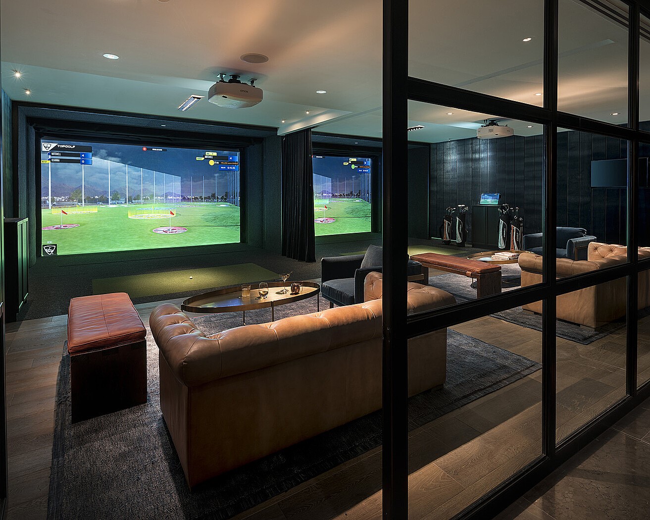 1111 Caroline Street, Unit 2908 Houston, TX 77010 - Photo 35 of 50 Private golf simulator lounge with plush seating, designed for year-round practice and entertainment.
