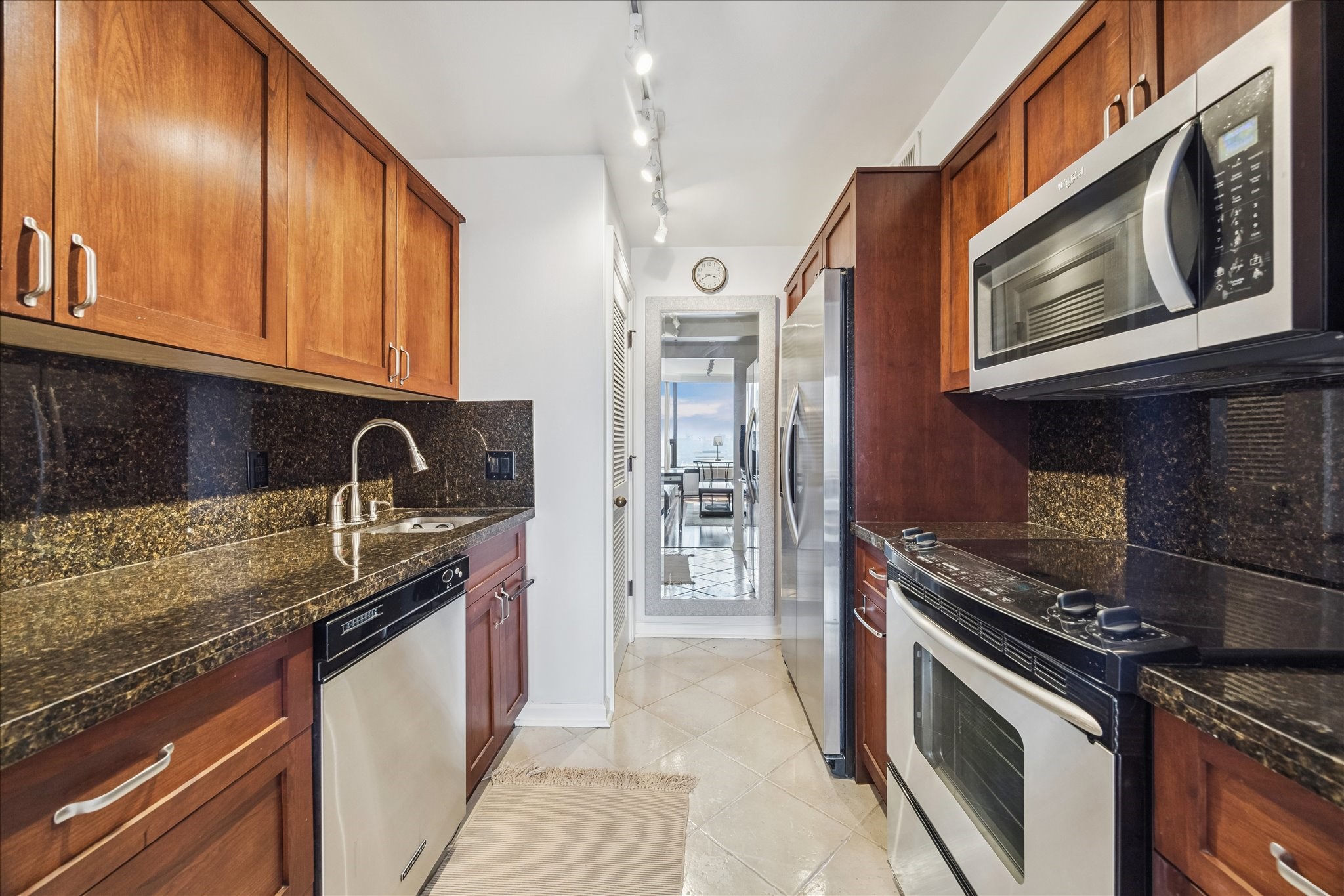 1111 Caroline Street, Unit 2908 Houston, TX 77010 - Photo 7 of 50 a kitchen with stainless steel appliances granite countertop a sink stove and refrigerator