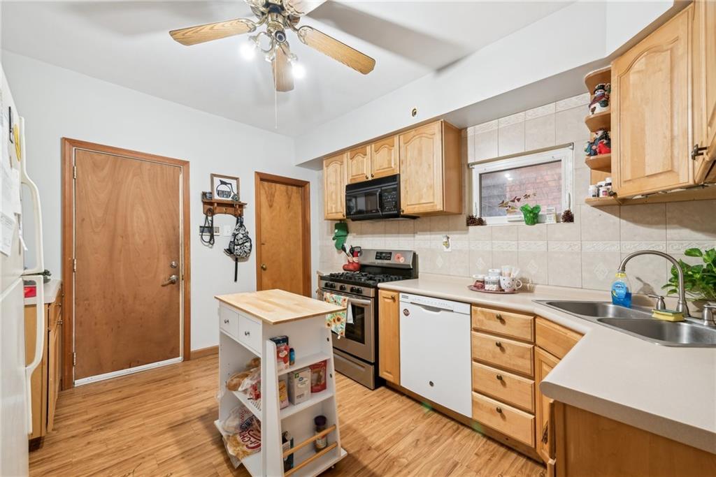851 Hober Avenue McKees Rocks, PA 15136 - Photo 12 of 32 a kitchen with stainless steel appliances kitchen island granite countertop a sink stove and refrigerator