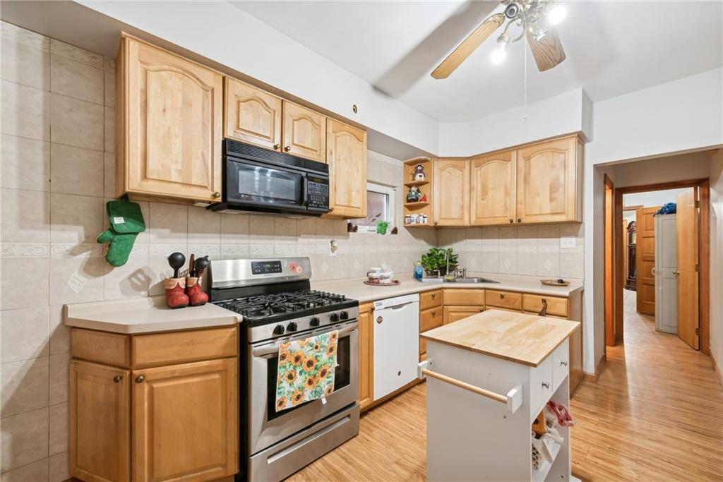 851 Hober Avenue McKees Rocks, PA 15136 - Photo 13 of 32 a kitchen with a stove a sink and a microwave