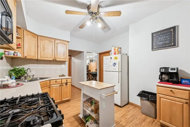 a kitchen with a refrigerator and a stove top oven
