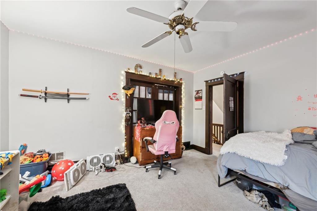 851 Hober Avenue McKees Rocks, PA 15136 - Photo 16 of 32 a bed room with a bed and a chandelier