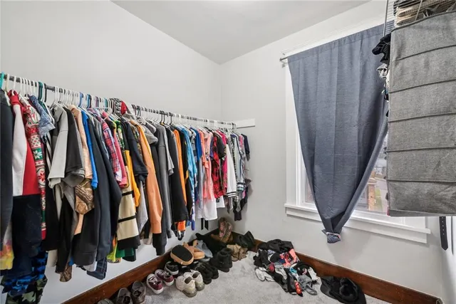 a view of walk in closet with clothes