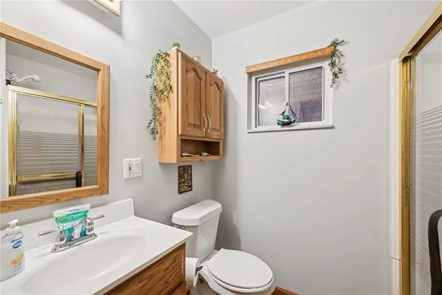 a bathroom with a sink a toilet and a mirror