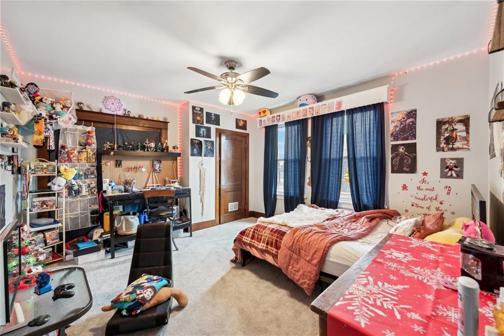 851 Hober Avenue McKees Rocks, PA 15136 - Photo 21 of 32 a bedroom with a bed a standing and a bookshelf