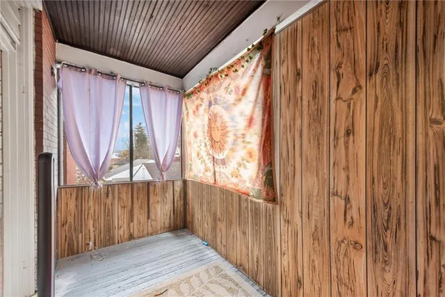 a view of a porch with wooden floor and stairs