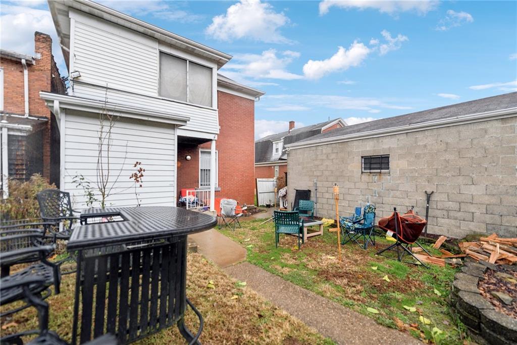 851 Hober Avenue McKees Rocks, PA 15136 - Photo 30 of 32 a view of a patio with table and chairs with wooden floor and fence