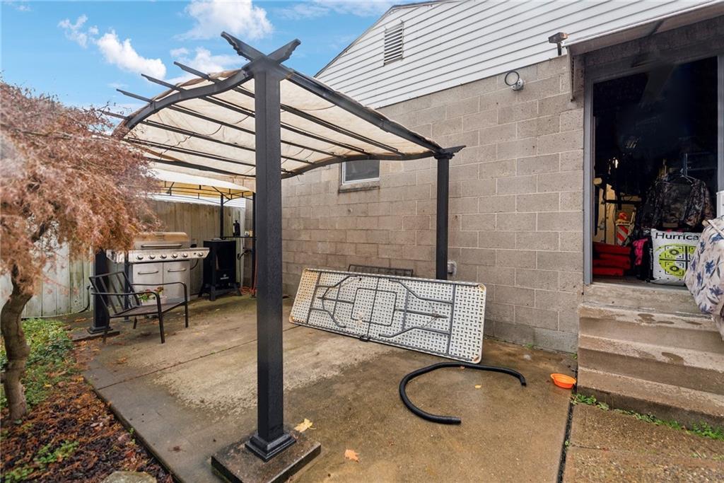 851 Hober Avenue McKees Rocks, PA 15136 - Photo 31 of 32 a backyard of a house with barbeque oven table and chairs