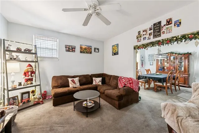 a living room with furniture a couch and a bookshelf