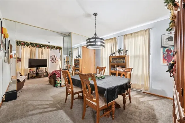 a dining room with furniture window and wooden floor