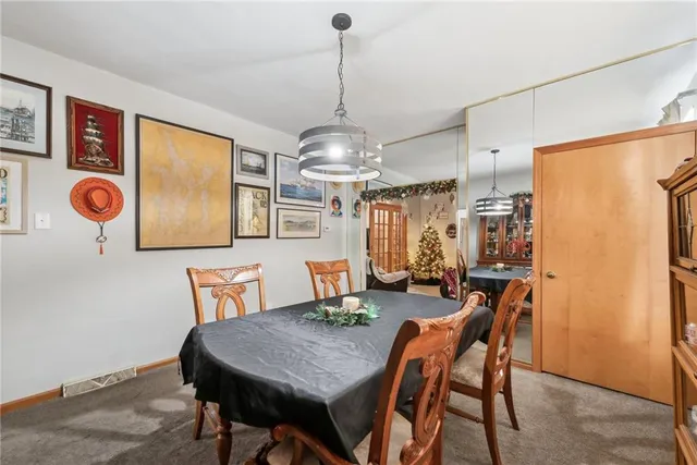 a view of a dining room with furniture and chandelier