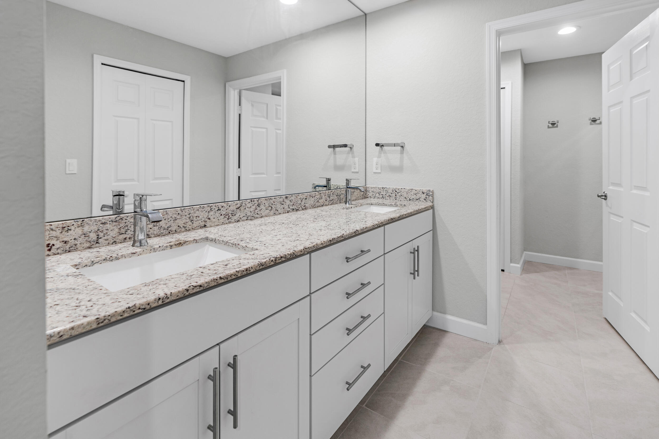 14533 Dulce Real Avenue Fort Pierce, FL 34951 - Photo 19 of 42 a bathroom with double sink and a mirror