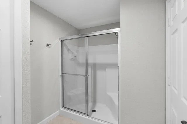 a bathroom with a glass shower door