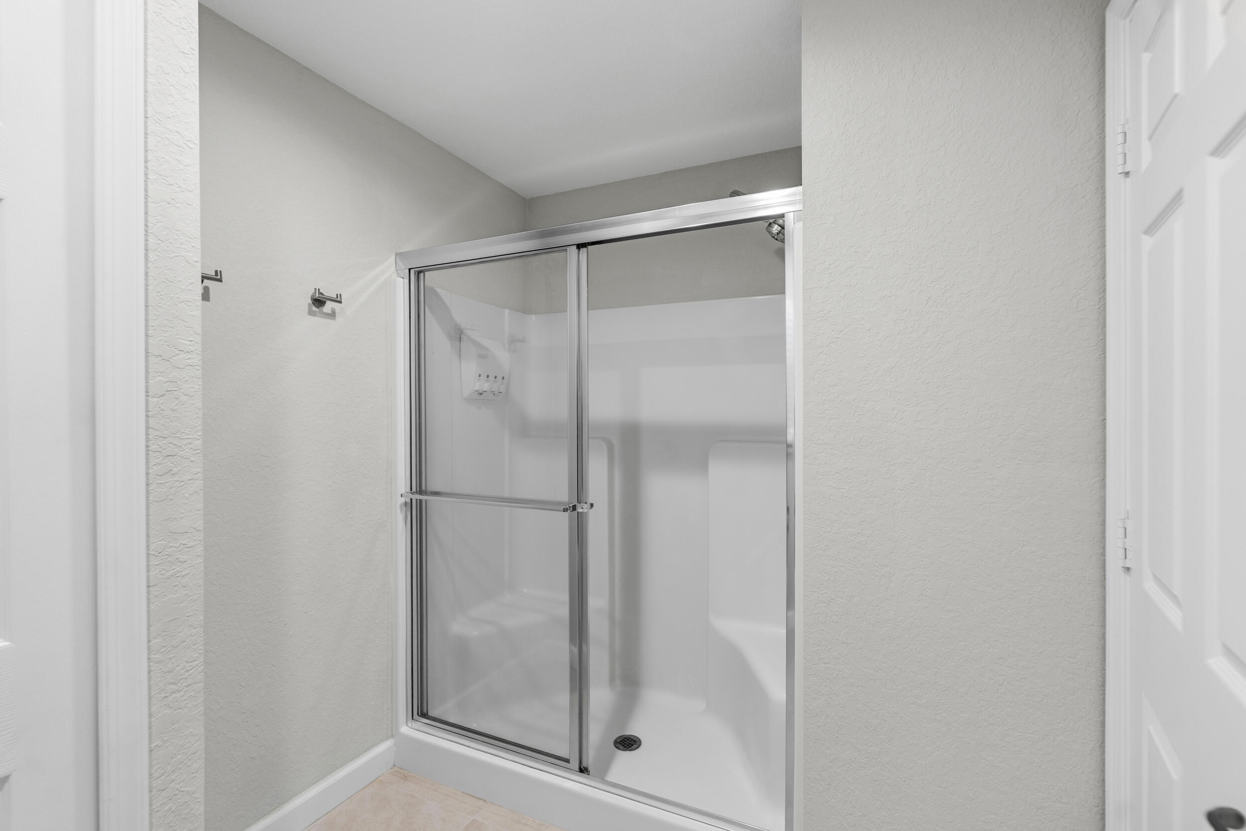 14533 Dulce Real Avenue Fort Pierce, FL 34951 - Photo 20 of 42 a bathroom with a glass shower door