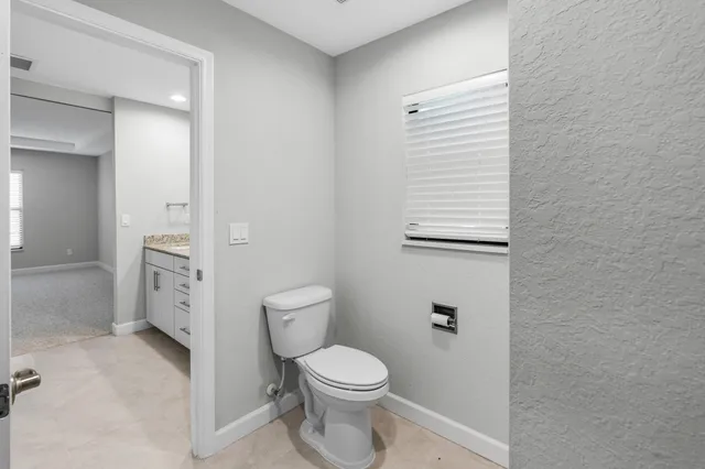 a white toilet sitting next to a bathroom sink