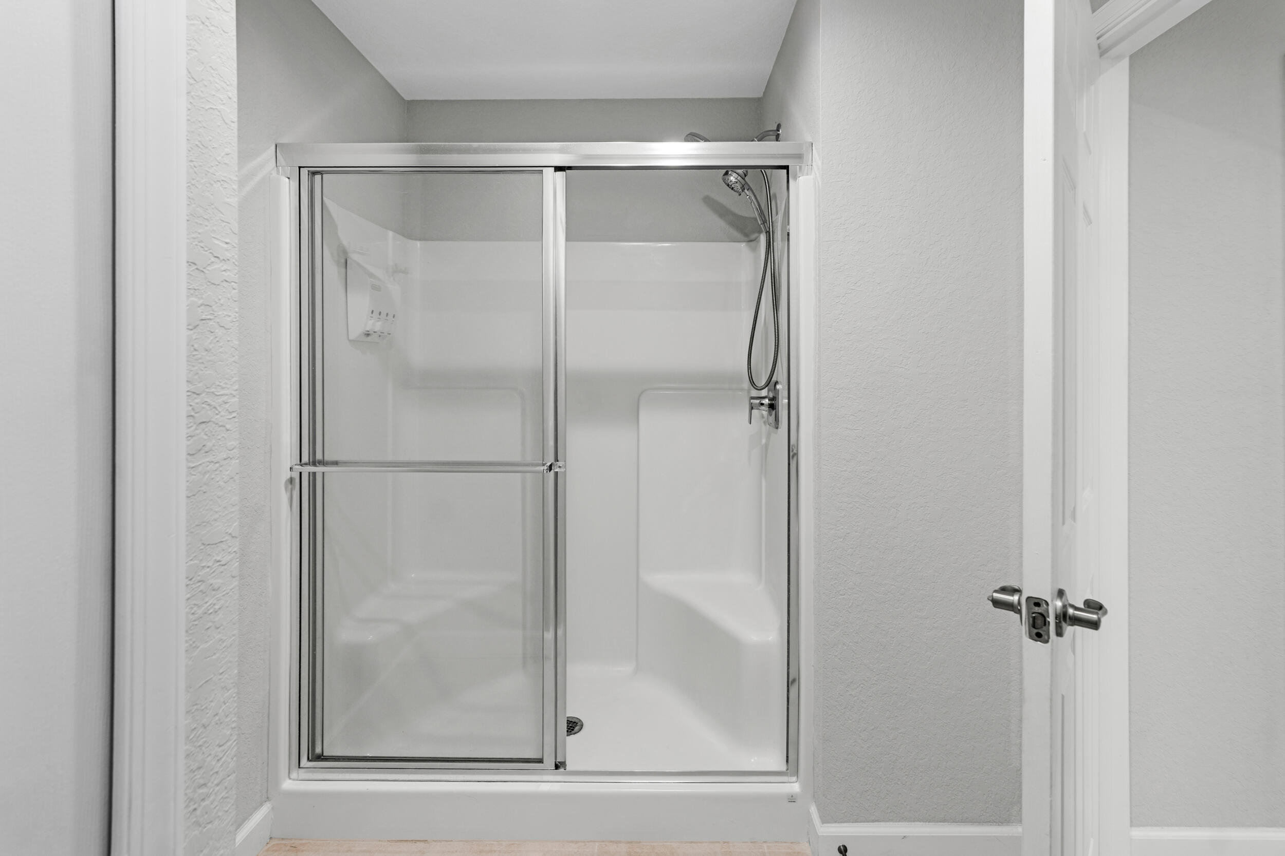 14533 Dulce Real Avenue Fort Pierce, FL 34951 - Photo 22 of 42 a bathroom with a glass shower door