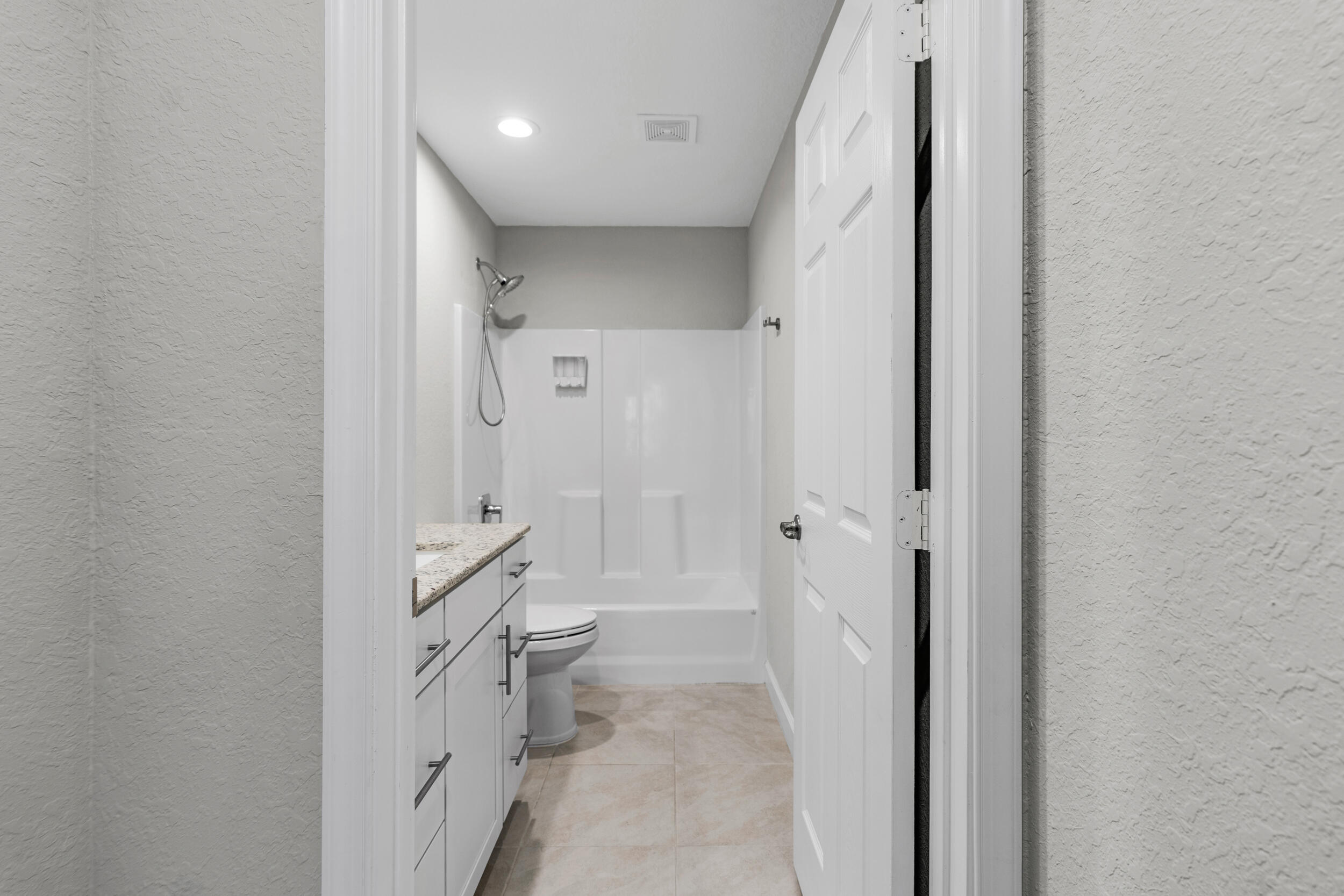14533 Dulce Real Avenue Fort Pierce, FL 34951 - Photo 25 of 42 a bathroom with a granite countertop sink mirror vanity and toilet