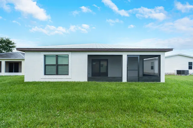 a house that has a big yard with wooden fence