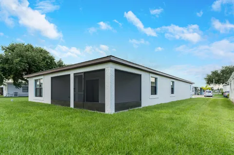 a view of an house with backyard space and garden