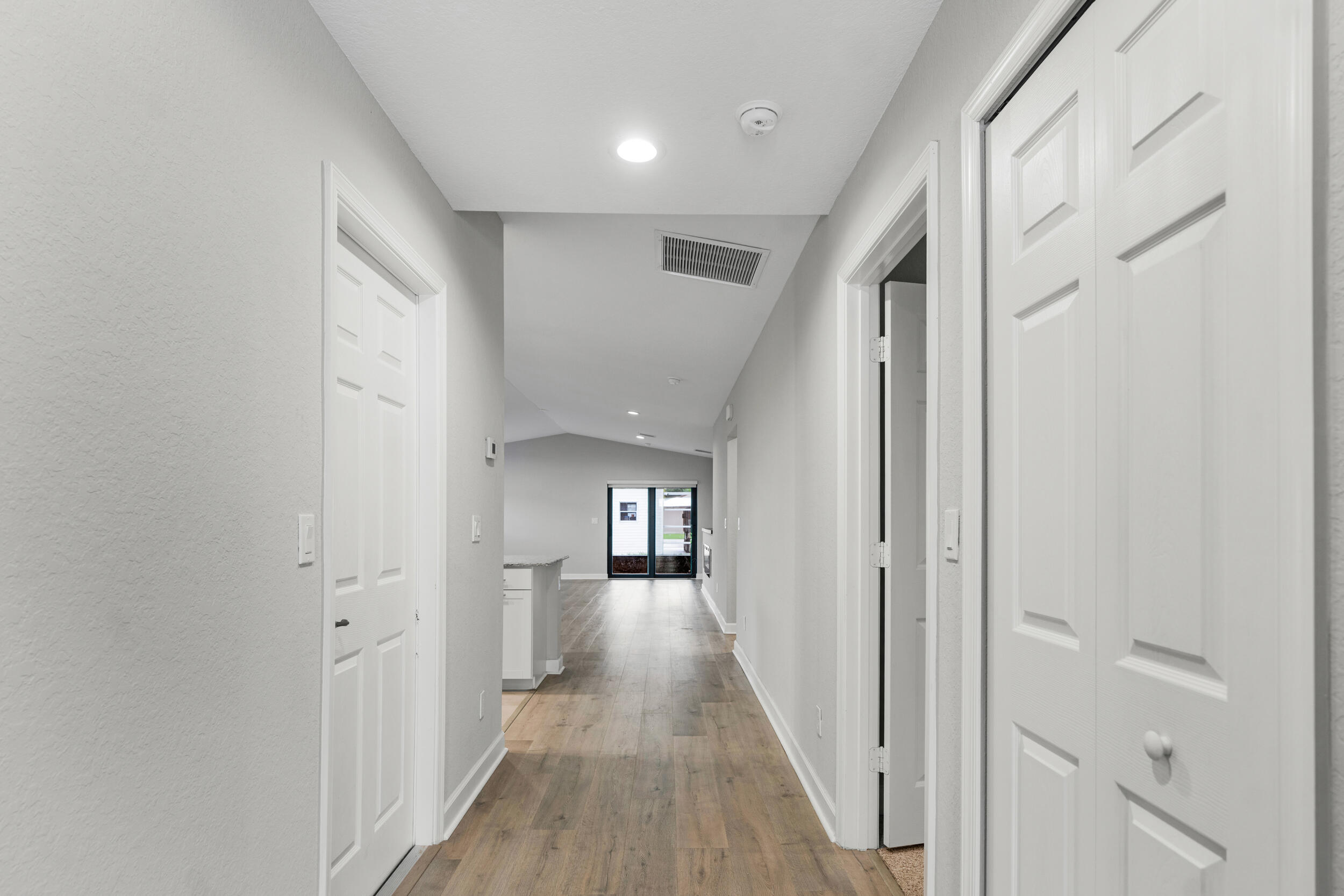 14533 Dulce Real Avenue Fort Pierce, FL 34951 - Photo 6 of 42 a view of a hallway with wooden floor and windows