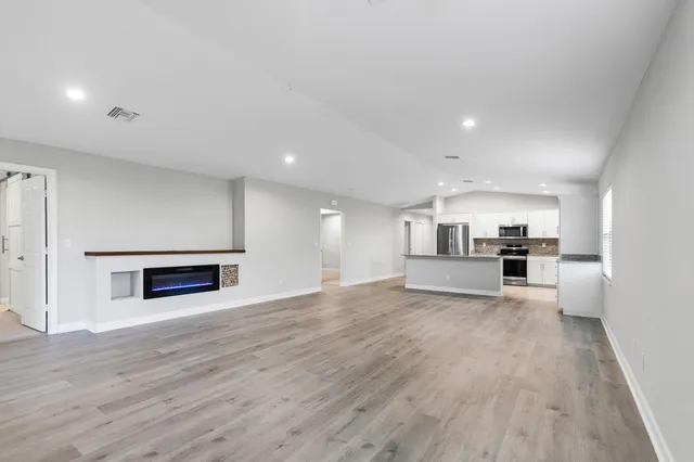 a view of kitchen with cabinets and wooden floor