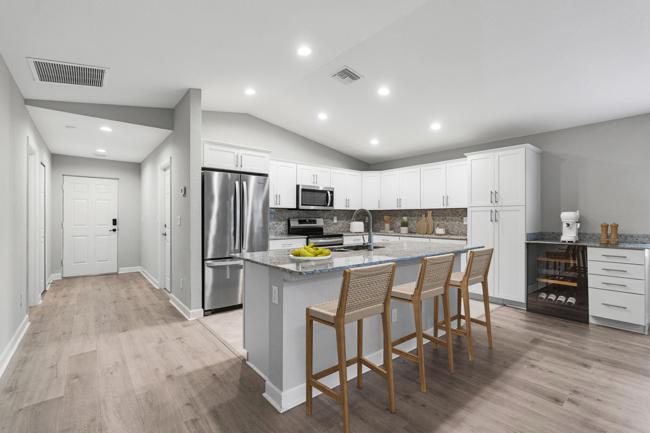 14533 Dulce Real Avenue Fort Pierce, FL 34951 - Photo 10 of 42 a kitchen with refrigerator and chairs