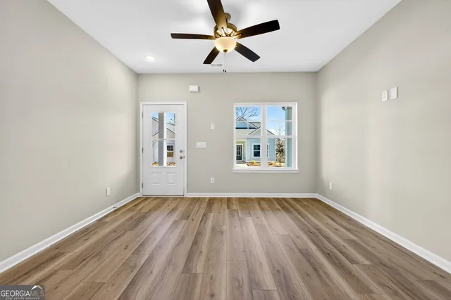 wooden floor in an empty room with a window