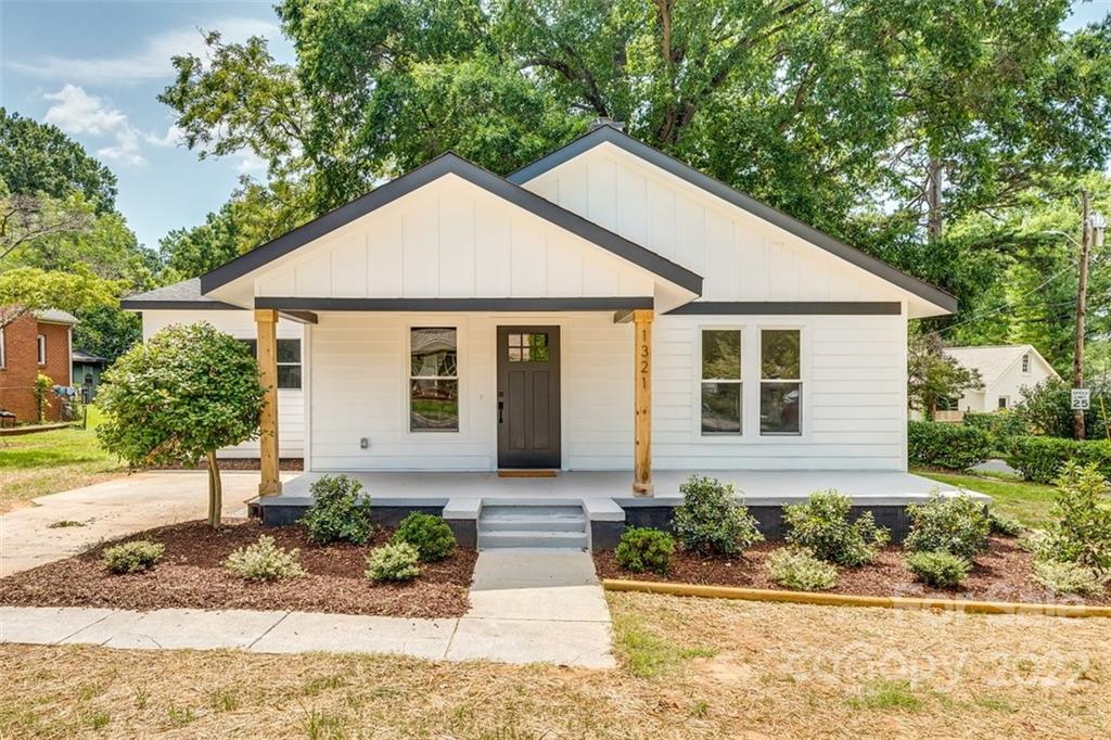 1321 Enderly Road Charlotte, NC 28208 - Photo 1 of 26 a front view of a house with a yard and potted plants