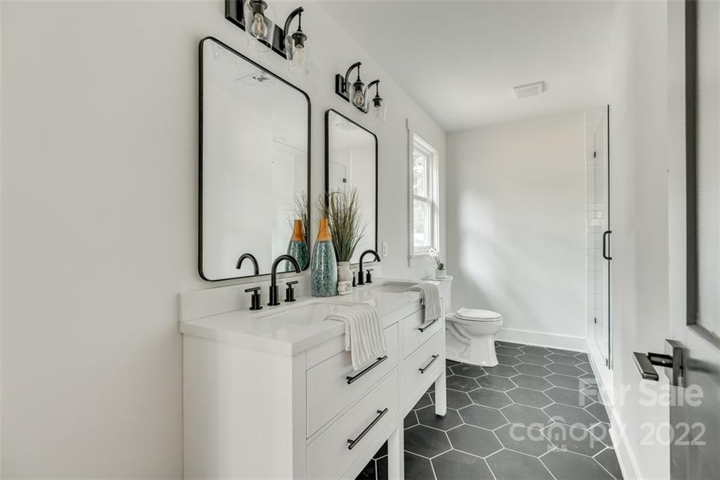 1321 Enderly Road Charlotte, NC 28208 - Photo 16 of 26 a bathroom with a double vanity sink mirror and toilet