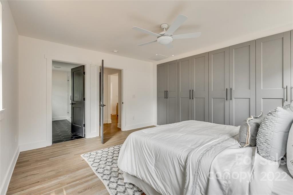 1321 Enderly Road Charlotte, NC 28208 - Photo 17 of 26 a bedroom with a bed and a chandelier