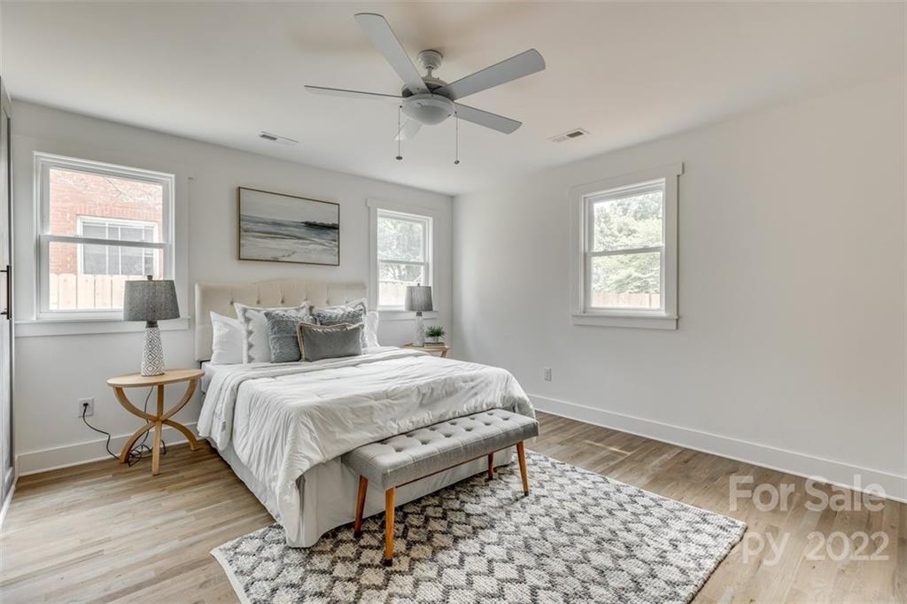 1321 Enderly Road Charlotte, NC 28208 - Photo 18 of 26 a bedroom with a bed lamp and a window