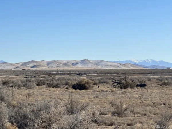 a view of a large mountain with mountains in the background