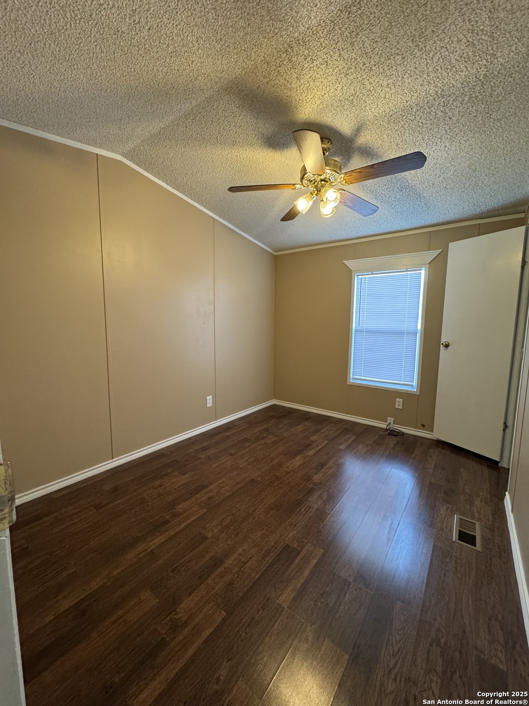 110 Deer Park Road, Unit B La Vernia, TX 78121 - Photo 3 of 12 a view of an empty room with wooden floor