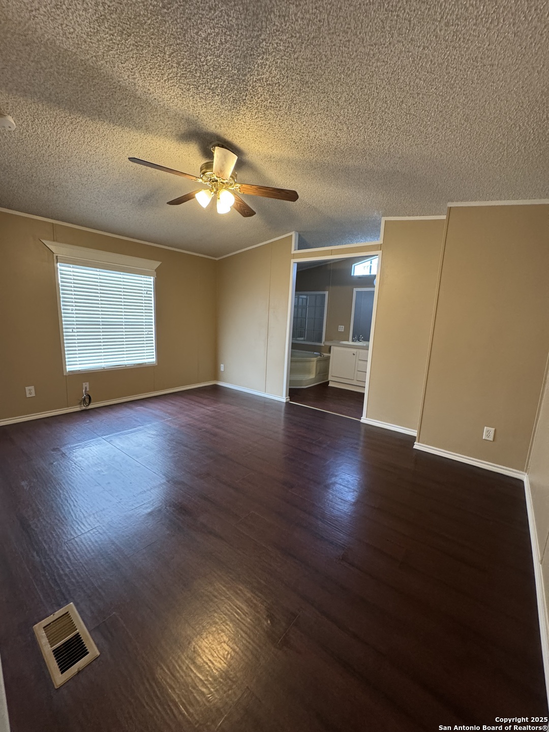 110 Deer Park Road, Unit B La Vernia, TX 78121 - Photo 8 of 12 a view of an empty room with wooden floor and a window