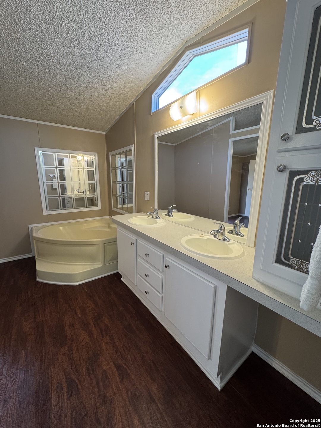 110 Deer Park Road, Unit B La Vernia, TX 78121 - Photo 9 of 12 a bathroom with a sink a mirror and a bathtub