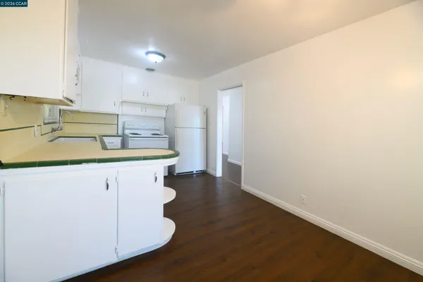 a kitchen with a sink cabinets and wooden floor