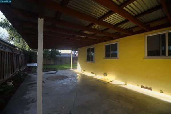a view of a backyard with wooden fence