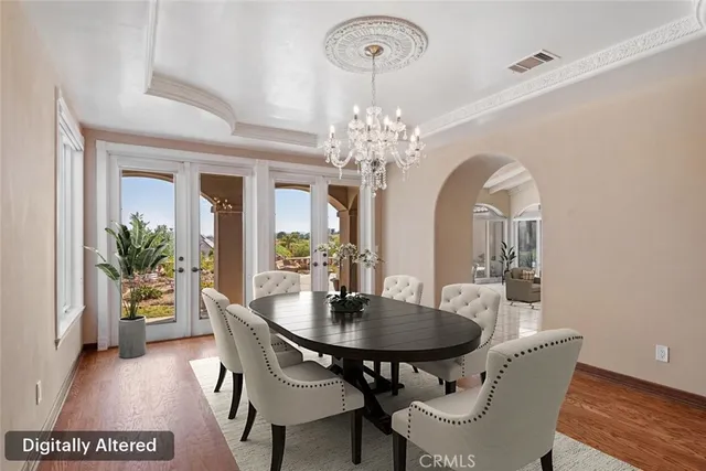 a view of a dining room with furniture and chandelier