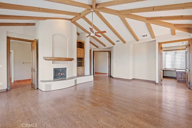 a view of a livingroom with an empty space and a fireplace