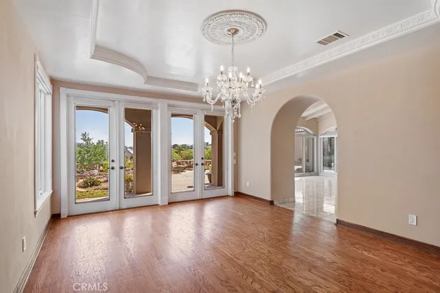 a view of a room with wooden floor and potted plant