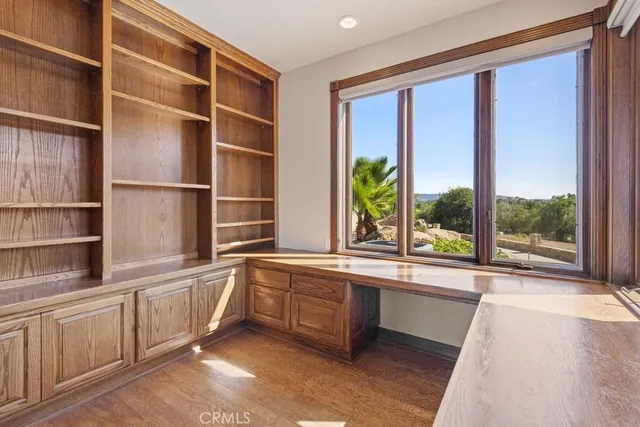 a kitchen with a large window and cabinets