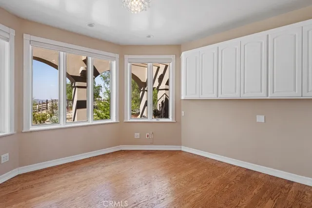 a view of an empty room with window and cabinet