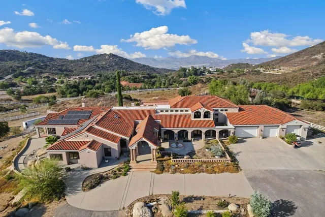 an aerial view of a houses with a city street