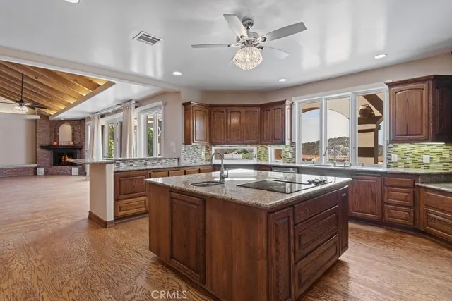 a kitchen with stainless steel appliances granite countertop a sink and cabinets