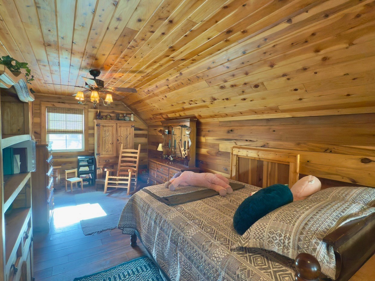 161 Fowler Road Woodbury, TN 37190 - Photo 34 of 69 a bedroom with a bed and wooden floor