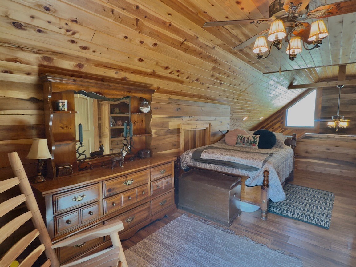 161 Fowler Road Woodbury, TN 37190 - Photo 35 of 69 a room with lots of wooden furniture and a chandelier