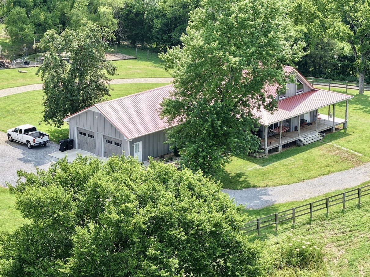 161 Fowler Road Woodbury, TN 37190 - Photo 66 of 69 aerial view of a house with a yard and table and chairs under an umbrella